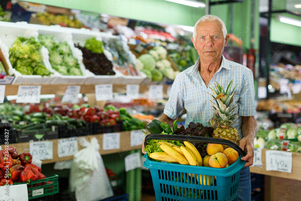 Senior man with basket with fresh greengrocery