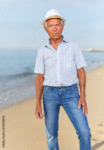 Cheerful mature man in headwear posing