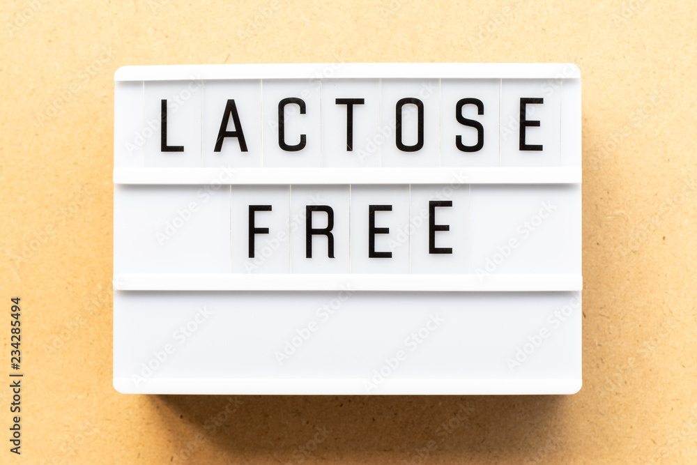 Light box with word lactose free on wood background Light box with word lactose free on wood background