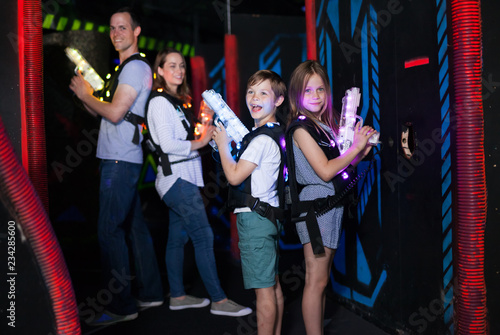 Kids standing back to back with laser pistols © JackF