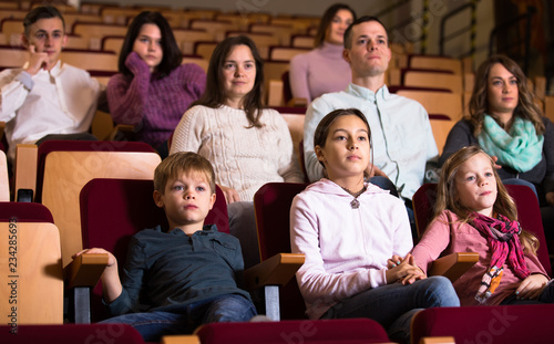 Spectators attentively watching a movie