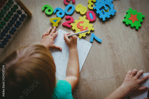 little boy and girl learn to write and calculate numbers