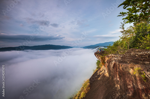 Young girl are taking photos the sea of mist on high mountain in Nakornchoom, Phitsanulok province, Thailand.