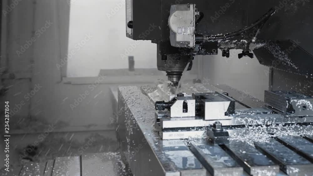 Tech process of metalwork and machine manufacturing of press form close up. Cnc metal working machine cut and drill molds with oil or coolant. Precision milling work. Tech process of metalwork and machine manufacturing of press form close up. Cnc metal working machine cut and drill molds with oil or coolant. Precision milling work.