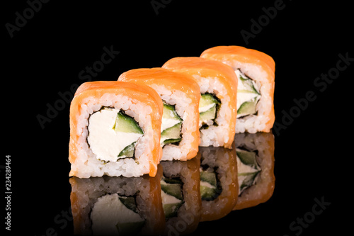 Japanese rolls on black background isolated with reflections