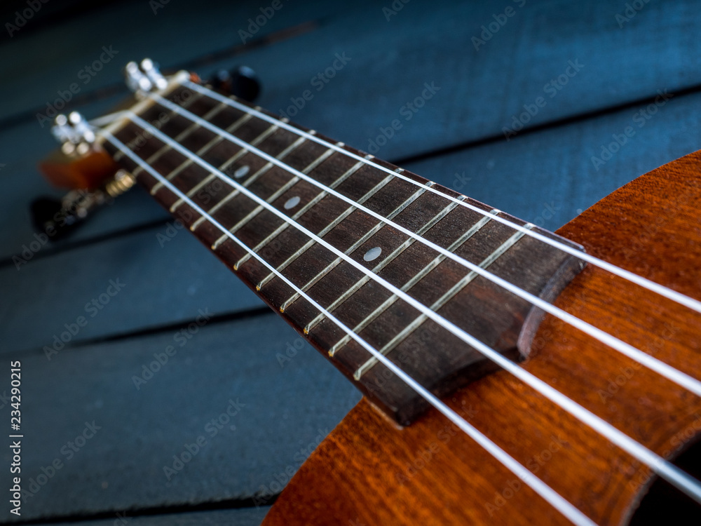 detail of ukulele, hawaii guitar with shallow depth of field. detail of ukulele, hawaii guitar with shallow depth of field.