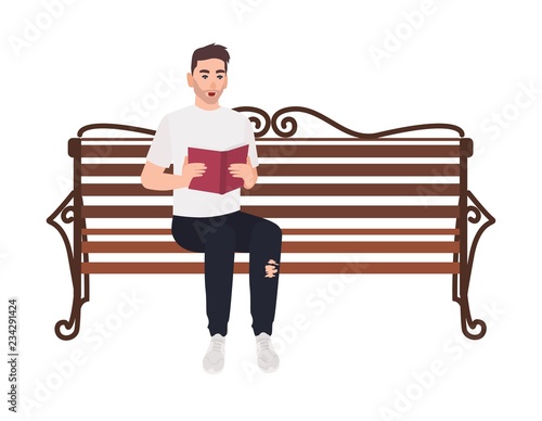Guy dressed in casual clothes sitting on street bench and reading book
