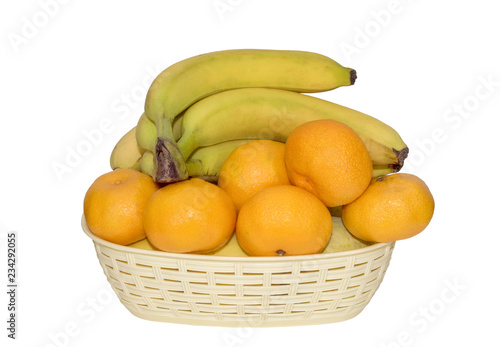  ripe tangerines and bananas in a basket isolated