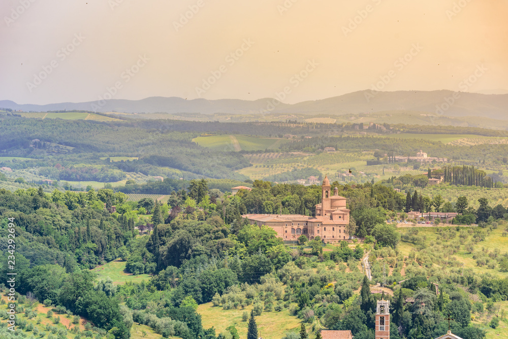 Fototapeta premium Historic town Siena, Tuscany - Aerial view with beautiful landscape scenery on a sunny summer day, walled medieval hill town with towers in the province of Siena, Italy- Europe