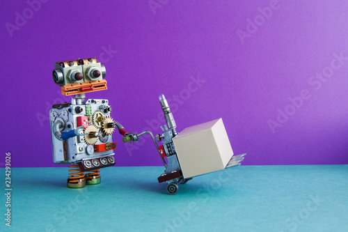 Courier robot moving pushcart with gray box parcel. Purple wall, green floor background. Copy space