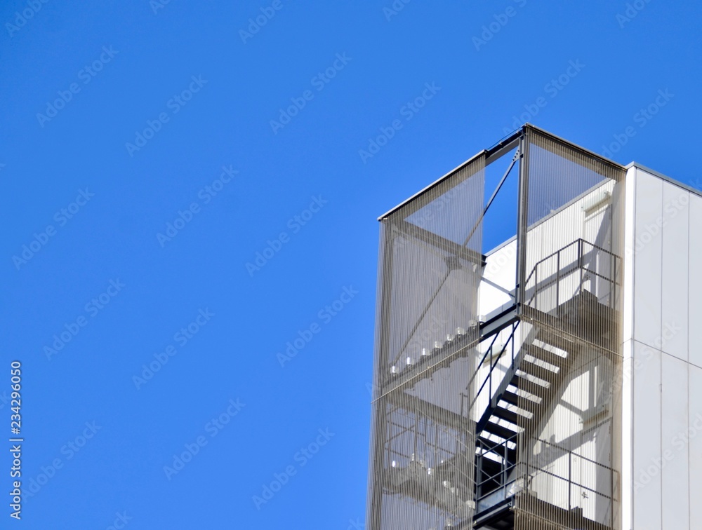 Geometric building and steal stair with rich blue sky