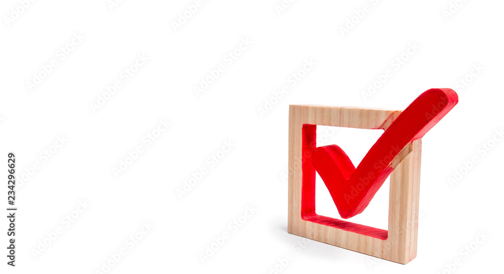 A wooden checkmark in the box on a white isolated background. The concept of suffrage, voting in elections. Election of the President or Government. Democracy, development, civil initiative. A wooden checkmark in the box on a white isolated background. The concept of suffrage, voting in elections. Election of the President or Government. Democracy, development, civil initiative.
