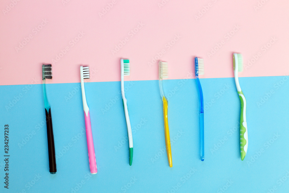 Toothbrushes on pink and blue background. Dental care. Toothbrushes on pink and blue background. Dental care.