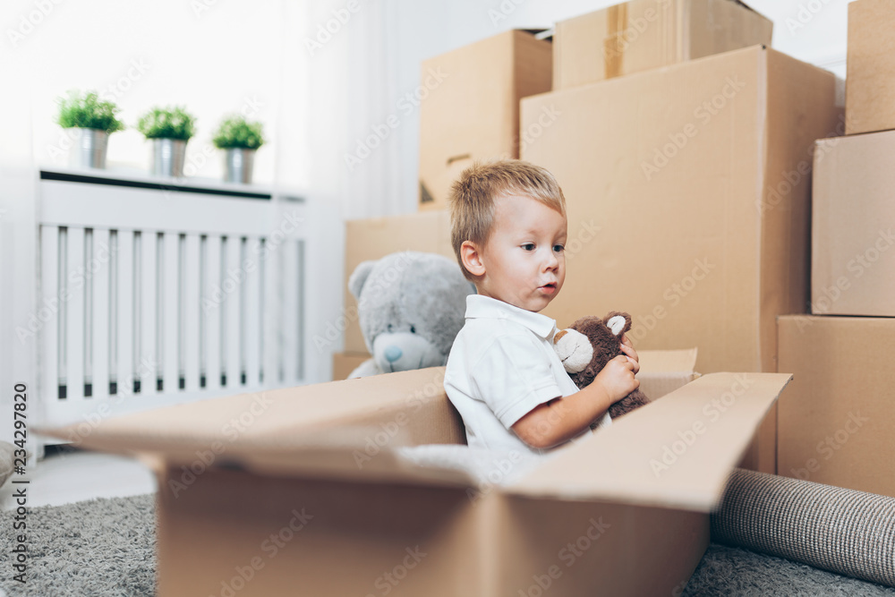 Cute toddler helping out packing boxes Cute toddler helping out packing boxes