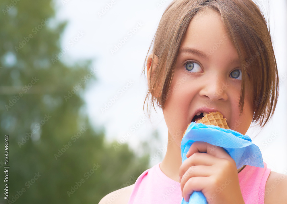 Pretty little girl eating licking big ice cream in waffles cone happy laughing on nature background Pretty little girl eating licking big ice cream in waffles cone happy laughing on nature background