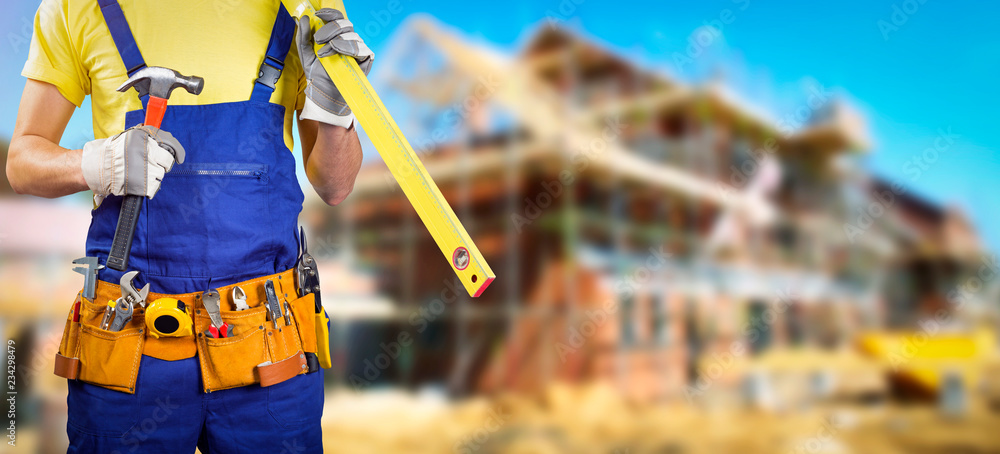 Fototapeta pracownik z paskiem narzędzi w budowie domu
