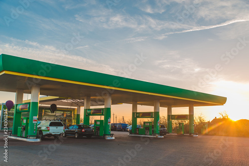 Schilderij op canvas wide view of gas station on sunset