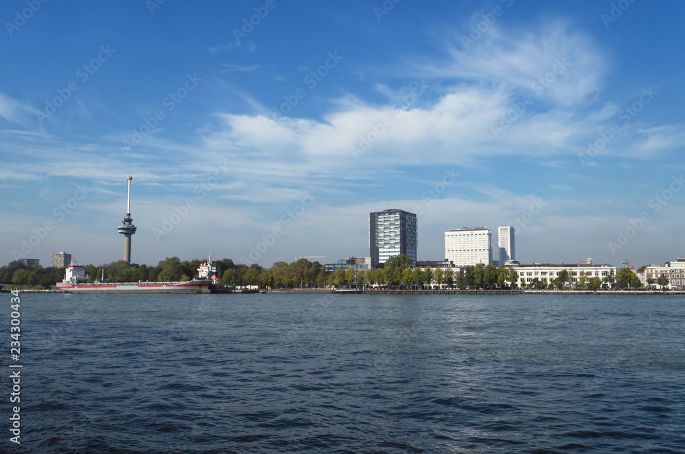 Obraz premium view on euromast and cityscape of Rotterdam from river bank