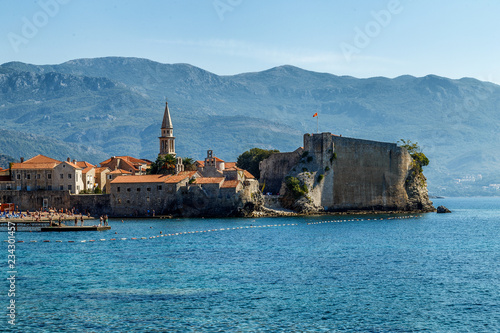 View of the city of Budva in the morning from the shore, on the horizon of the mountain