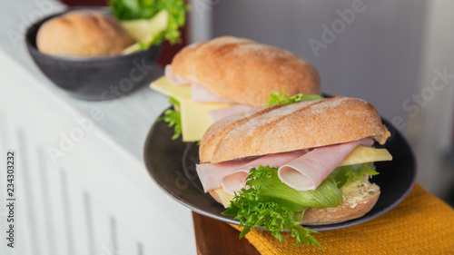 Ciabatta baguette sandwiches with ham, cheese and lettuce