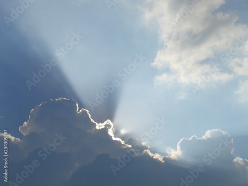Bright sky with the sun ray behind the cloud.  Scenic clouds and sky  beautiful sky and sunlight behind clouds.  Full frame shot of sky with the sun ray behind the cloud.  Wonderful sky and sunray.