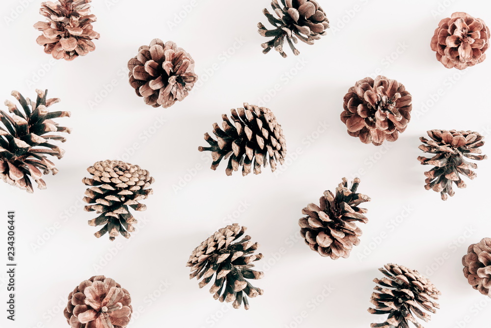 Christmas creative composition. Pine cones pattern on white background. Christmas, New Year, winter concept. Flat lay, top view, copy space Christmas creative composition. Pine cones pattern on white background. Christmas, New Year, winter concept. Flat lay, top view, copy space