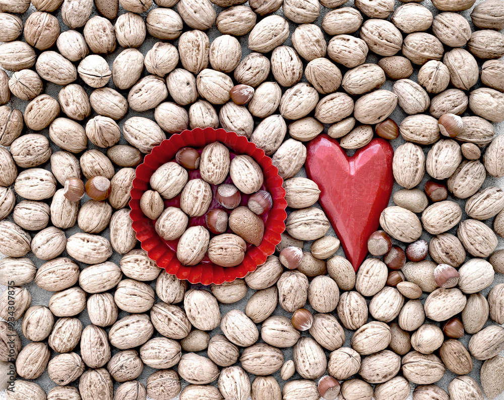 Christmas decoration of wooden heart and variety of nuts. Christmas decoration of wooden heart and variety of nuts.