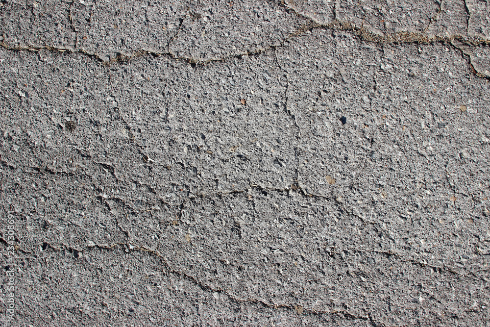 Old asphalt surface texture detail with cracks fractures lines close up Old asphalt surface texture detail with cracks fractures lines close up