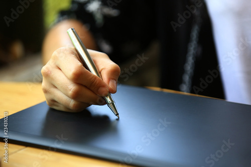 business woman drawn or writing on black electronic board, Businesswoman's hand with pen writing on notepad