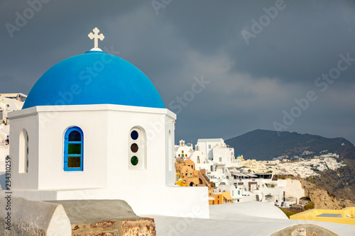 Traditional and famous houses and churches with blue domes in Oia, Santorini, Greece
