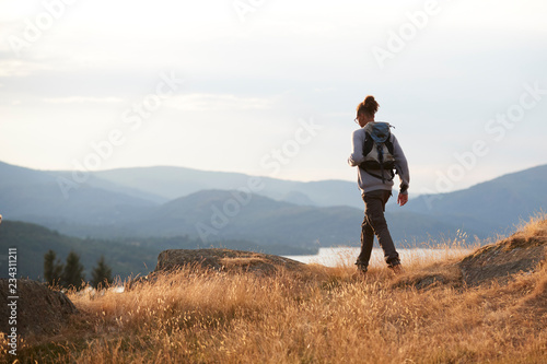 A young mixed race man hiking alone on a mountain peak, back view © Monkey Business
