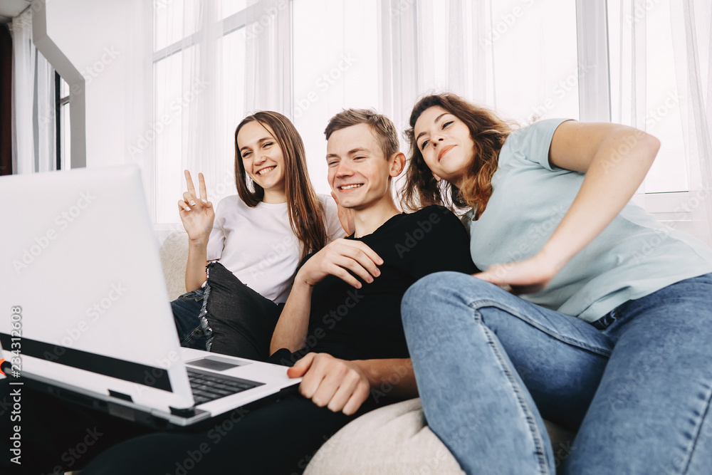 friendship, conversation, modern technology, chatting. group of young people waving to their friends during video call using laptop friendship, conversation, modern technology, chatting. group of young people waving to their friends during video call using laptop