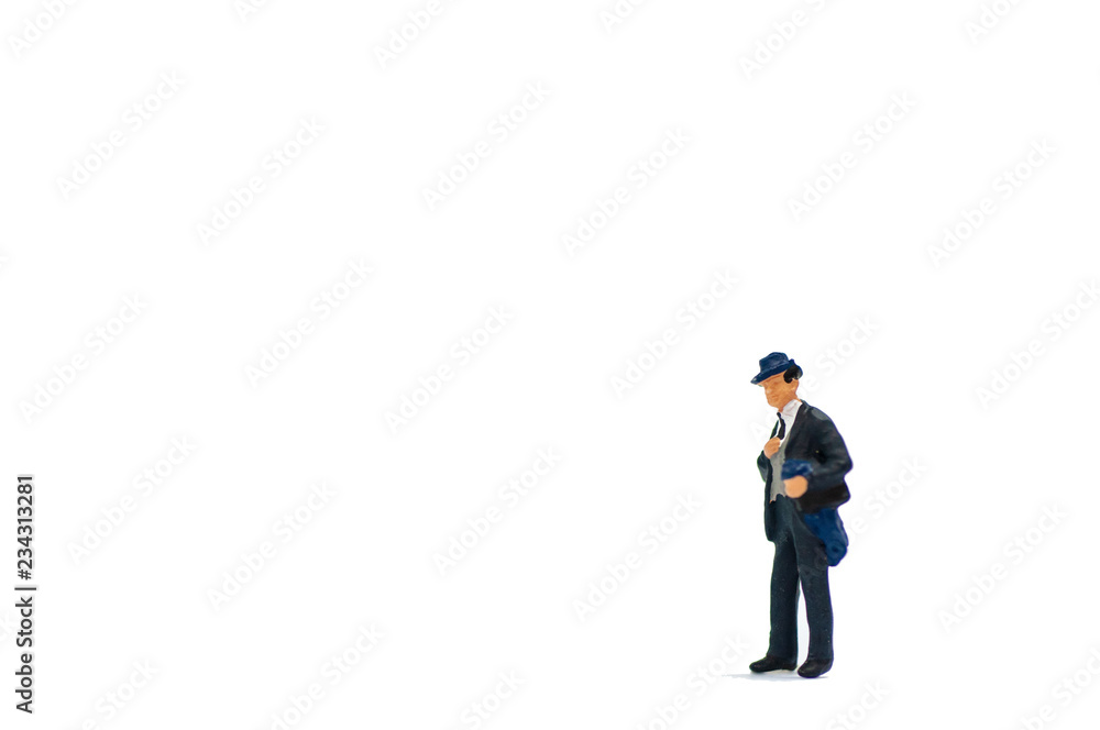 Selective focus miniature business people activity on white background with copy space. Selective focus miniature business people activity on white background with copy space.