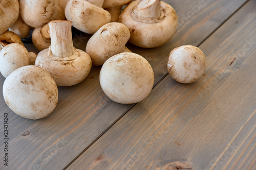 Champignon mushrooms on a wood background