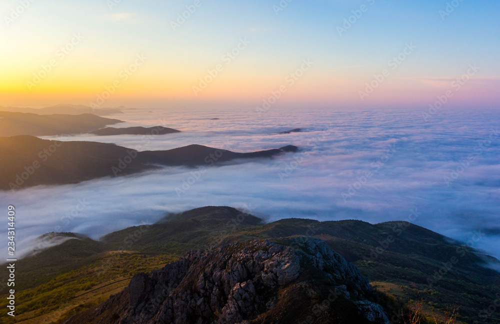 Beautiful sunset in the Crimean mountains, Crimea. Majestic sunset in the mountains landscape with sunny beams.