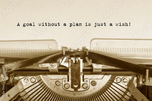 A goal without a plan is just a wish!  typed words on a vintage typewriter with vintage background.