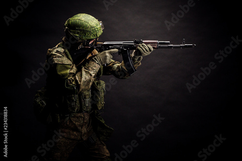 russian special forces soldier with rifle on dark background. army, military and people concept