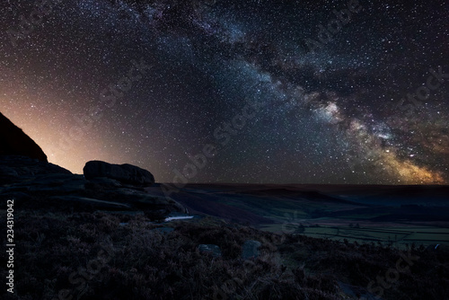 Vibrant Milky Way composite image over landscape of Peak District National Park in England © veneratio