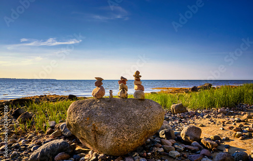 Fototapeta Naklejka Na Ścianę i Meble -  Three cairns on a stone at the beach on the Baltic Sea in Hohen Wieschendorf.