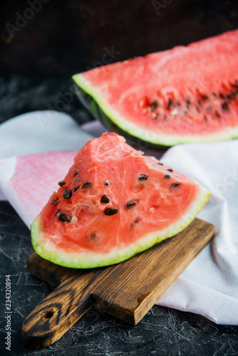 Slices of fresh ripe watermelon on a concrete background