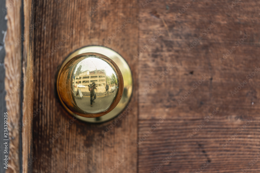 Fototapeta premium Rustic Antique Bronze Door knob wood reflection