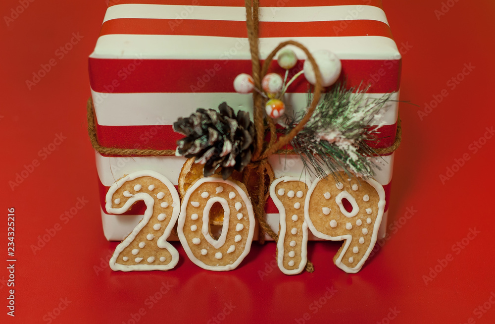 Christmas gifts on a red background with a red ribbon, with numbers 2019