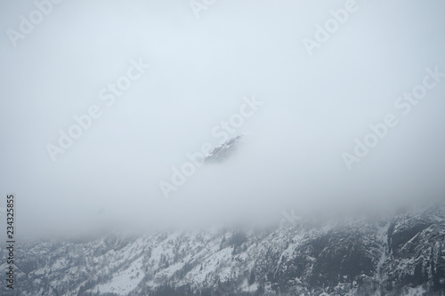 Pick of mountain covered by fog.