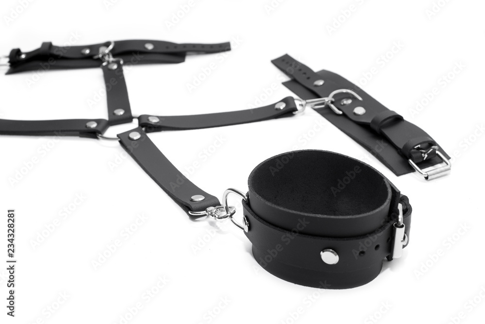 Obraz premium Black leather handcuffs isolated on white background. BDSM Kit