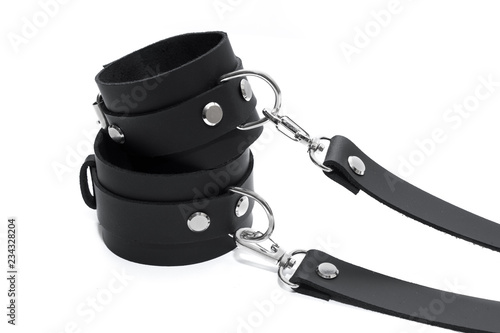 Black leather handcuffs isolated on white background. BDSM Kit