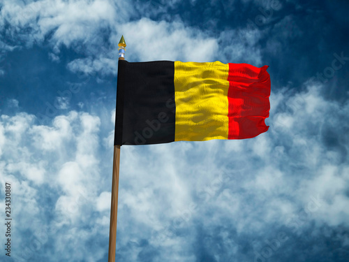 Belgium flag Silk waving flag of Belgium made transparent fabric with wooden flagpole gold spear on background sunny blue sky white smoke clouds real retro photo Countries of world 3d illustration