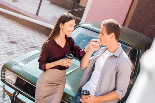 Man in love proposing a surprised woman to marry him. Proposal, engagement concept.Betrothal. Standing by new car and preparing for eurotrip on their honeymoon. Travallers in eurotour together photo