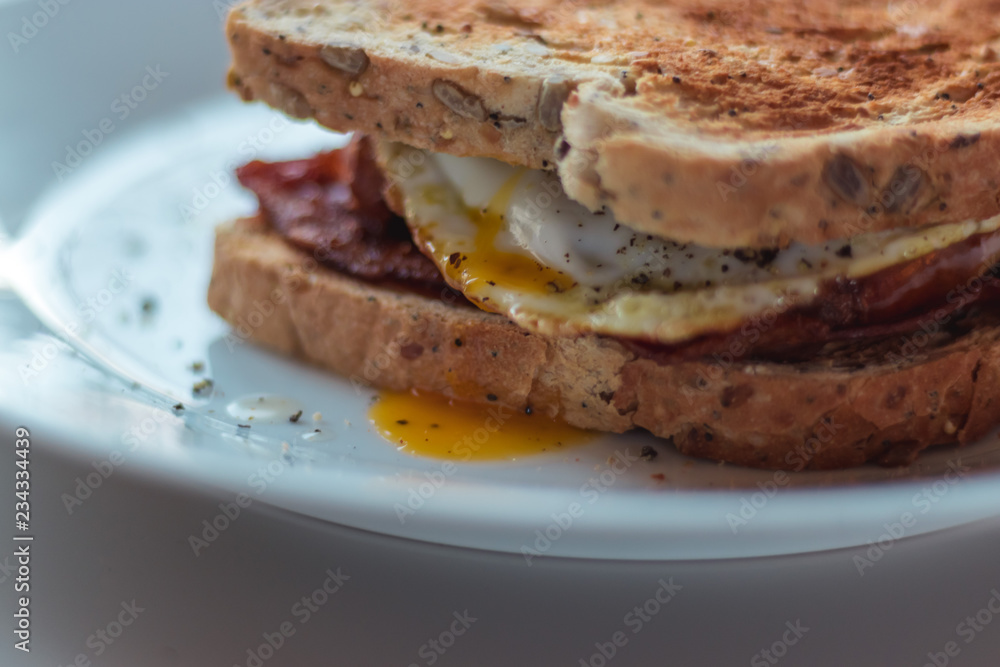 Homemade Breakfast Egg Sandwich with Cheese and bacon on Toast Homemade Breakfast Egg Sandwich with Cheese and bacon on Toast