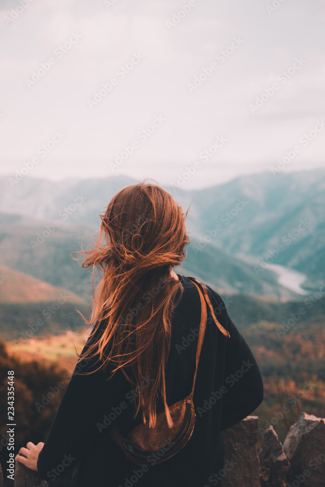Woman admiring view on windy day Woman admiring view on windy day