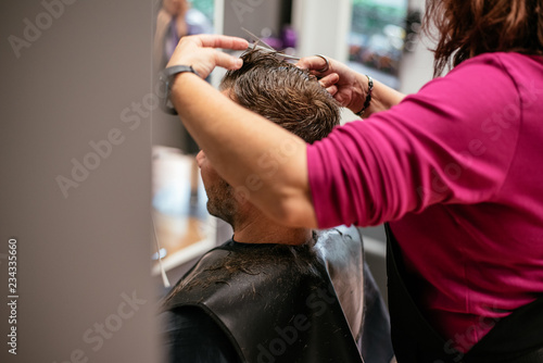 Man having his hair cut in a barbershop